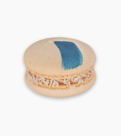 Bounty Macaron with coconut filling and chocolate shells featuring a bold blue stripe