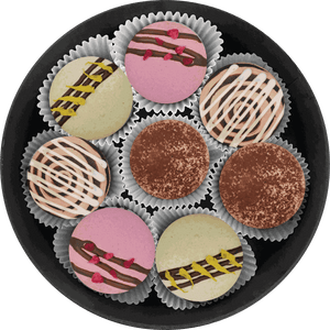 Sweet Morning set macarons with coffee, berry, and pistachio flavors displayed on a white plate